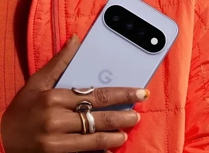 A hand with rings holding a lavender Google Pixel phone